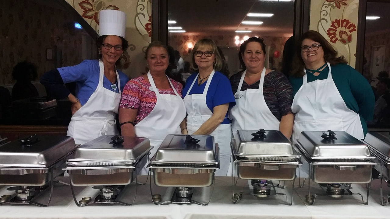 Courteous wait staff behind the buffet.