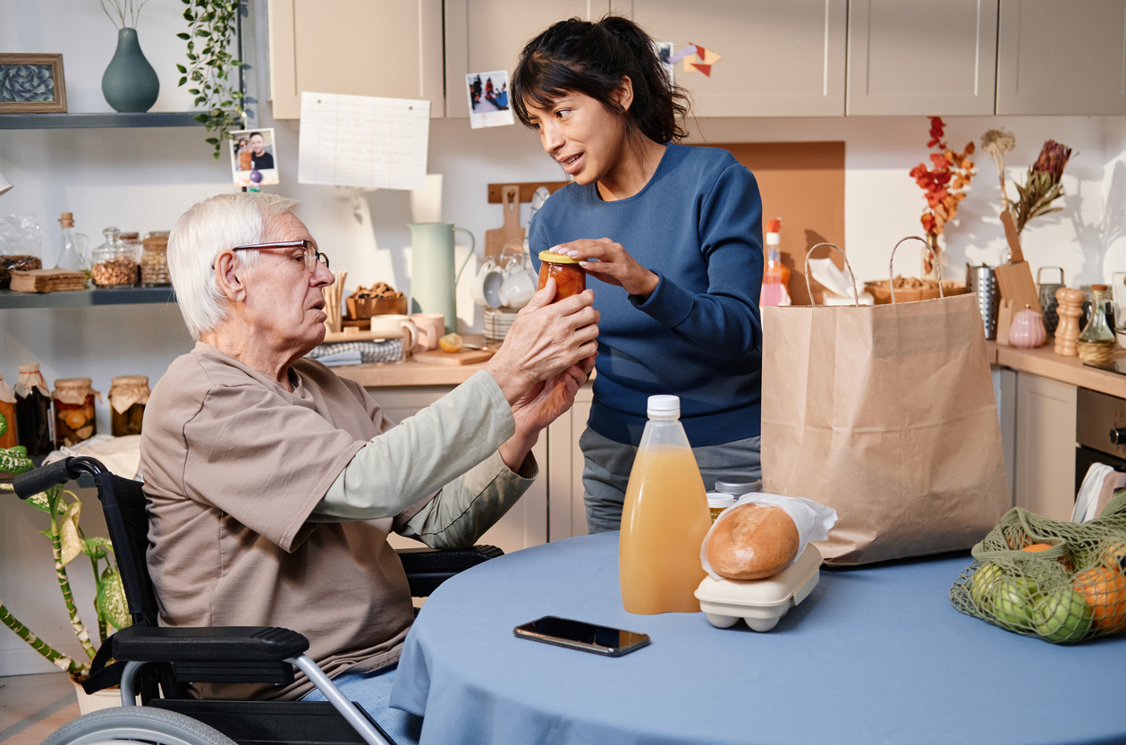 Senior in assisted living receiving help
